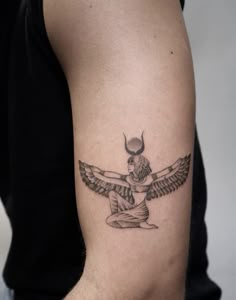 a tattoo on the arm of a man with an egyptian winged bird in it's center