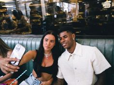 a man and woman sitting next to each other at a restaurant