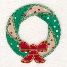 a christmas wreath with red and green ribbon