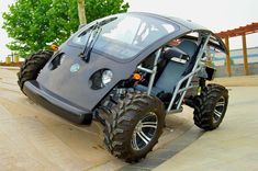 an off - road vehicle with four wheels parked on the side of a parking lot