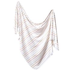 a white and orange striped blanket hanging on a wall