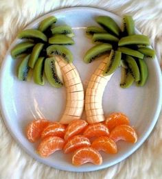 a white plate topped with sliced oranges and banana's on top of each other