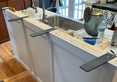 a kitchen counter being remodeled with tools on it