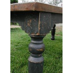 an old wooden table sitting in the grass