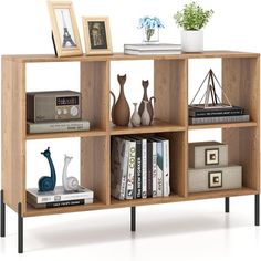 a book shelf with books, vases and pictures on it in front of a white background