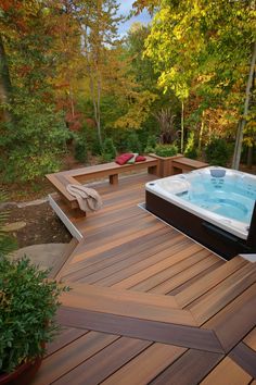 a hot tub sitting on top of a wooden deck