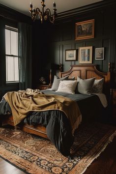 a bedroom with black walls and wooden bed frame, chandelier, rug, and painting on the wall