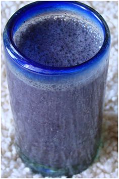 a blue glass sitting on top of a white carpet