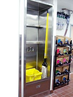 the inside of a building with several shelves and bins in it, including cleaning supplies