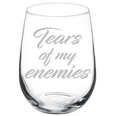 a wine glass with the words years of my enernies written on it in grey ink