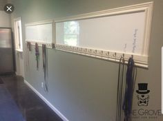 an office hallway with white walls and lots of magnets on the wall next to each other