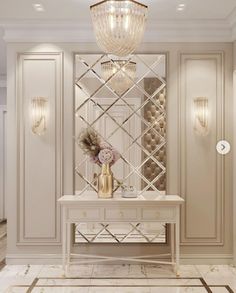 a white table sitting under a chandelier next to a wall mounted wine rack