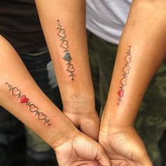 two people holding hands with tattoos on their arms that say i love you, mom and son