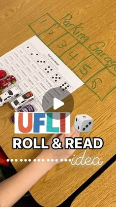 a child is playing with roll and read dice game on the table in front of them