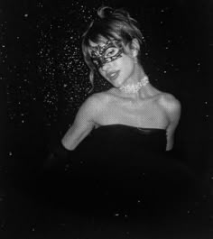 a black and white photo of a woman in a strapless dress with rain drops on her face