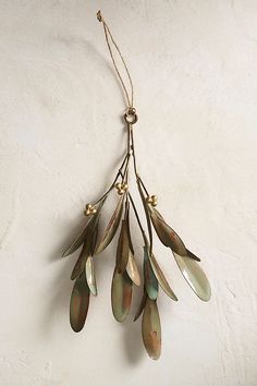 a bunch of metal leaves hanging from a wall