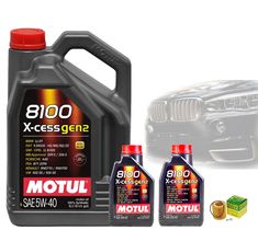 two bottles of motul 8100 x - ces gen2 engine oil next to a car