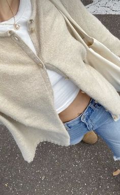 a woman is standing on the street with her hand in her pocket