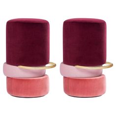 two velvet stools with gold rings on each one and pink, red, and purple colors