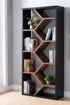 a bookshelf with several shelves and plants on top of it in front of a window