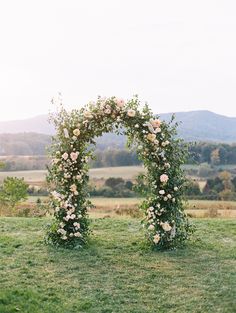 an outdoor wedding arch with flowers and greenery