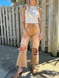 *PREORDER SHIPPING 7/25 - BEST SELLER* Our Sun Drenched Distressed Cropped Denim Jeans are such a cute twist on your every day denim. These jeans feature a stunning tan color, 90's vintage crop flare style, high waisted, distressed detail, and raw hemline. Style these jeans with your fave tees in the summer!! Styled with our "Sunhoney White Corduroy Hat" & "Back To Basics Crop Tank" Content: 100% Cotton Fit: TTS Model wearing size: 24 Model sizing: 0-2 top, 24 bottoms | Height: 5'3" Tan Jeans Outfit, Denim Style Casual, Ripped Jeans Women, Womens Ripped Jeans, Outfits Jeans, Tan Jeans, High Waisted Flare Jeans, Jean Large, High Waisted Flares