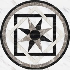 a black and white circular design with a star in the center on a marble background