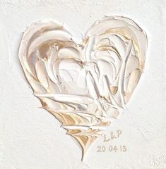 a painting of a white heart with gold foil on it's side and the words i love you