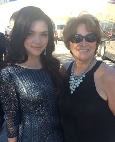 two women standing next to each other wearing sunglasses