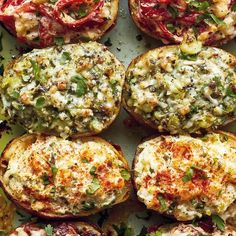 several different types of baked goods on a tray with tomatoes and other vegetables in the background