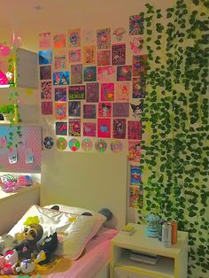 a bedroom decorated in pink, green and white with pictures on the wall above the bed