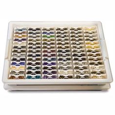 a white tray filled with lots of different colored beads