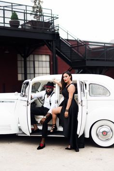 a man and woman sitting in the back of a white car