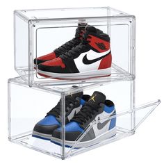 two pairs of sneakers are in a clear case on display, one is red and the other is blue