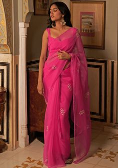 Featuring a stunning hot pink saree crafted from pure organza silk, adorned with delicate pink and gold floral motifs- Paired perfectly with a matching modern cut silk blouse, this ensemble radiates grace and sophistication. Composition : Saree - Silk Organza, Blouse - Silk Care: Dry Clean Only and Vacuum Storage This product can be customized for sleeves, length of blouse and neckline Delivery : 4-6 weeks as the product is hand crafted. Check Size Guide or choose MySize for free customisation ( Simple Saree Designs, Fashionable Saree Blouse Designs, Fancy Sarees Party Wear, Simple Sarees, Indian Fashion Saree, Saree Designs Party Wear, Indian Dresses Traditional, Traditional Indian Outfits, Embroidered Saree