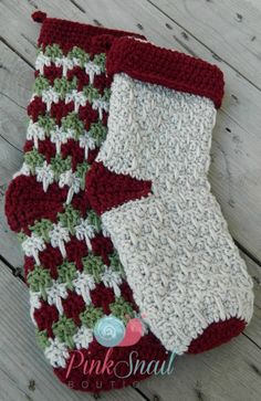 two crocheted christmas stockings sitting on top of a wooden floor