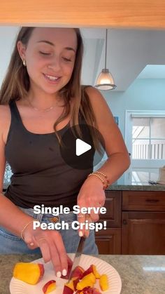 a woman cutting up some fruit on top of a white plate with the words single serve peach crisp