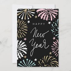 a happy new year card with fireworks and stars on the front, in black background