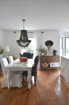 a dining room table and chairs in front of a window