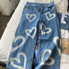 a pair of jeans with hearts painted on them