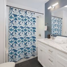 a blue and white shower curtain in a bathroom