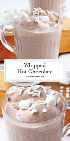 two cups filled with whipped hot chocolate and topped with marshmallows