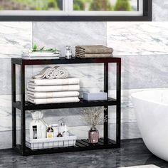 a bathroom shelf with towels, soaps and other personal care items on it next to a bathtub