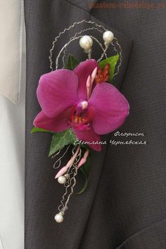 a purple flower is attached to the lapel of a suit