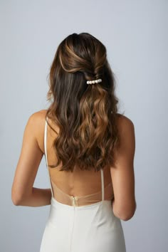 the back of a woman's head wearing a white dress