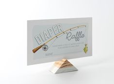 there is a business card with a fishing rod on it and the name diaper raffle