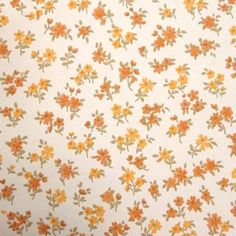 an orange and yellow flower pattern on white fabric