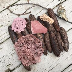 pine cones and doily are laid out on the ground next to some other items