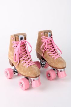 pair of roller skates with pink wheels on white background