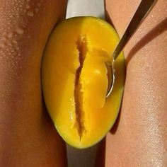 a close up of a person cutting an apple with a pair of scissors on it